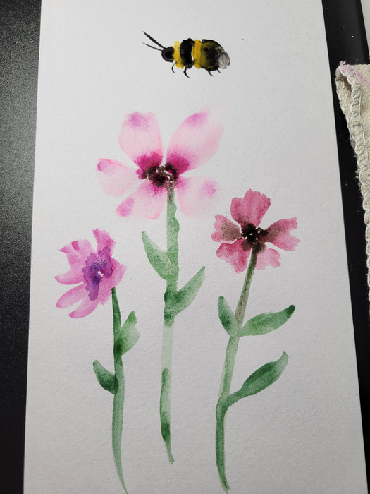 Loose watercolor study of pink wildflowers with two small bumblebees hovering above them