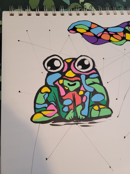 Cartoon frog filled with bright neurographic shapes and patterns on a spiral sketchbook page